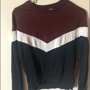a maroon, white and blue sweater